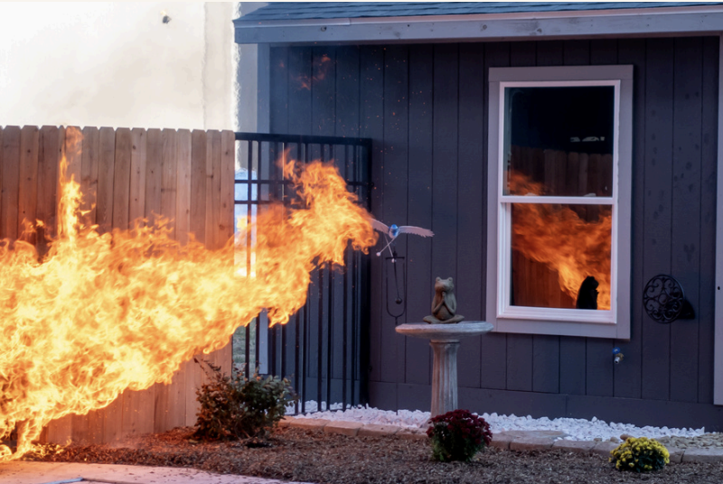 burning fence attached to home